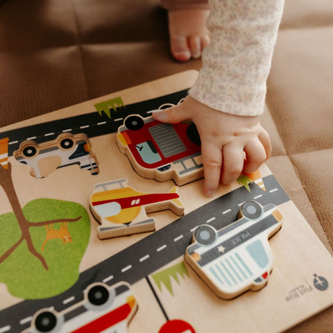 wooden puzzle emergency vehicles with childs hand